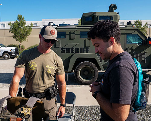A student and Riverside County Sheriff Deputy interact
