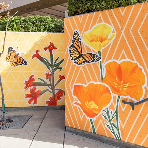 Upper platform of MVC in Bloom mural, with orange monarch butterflies and poppies