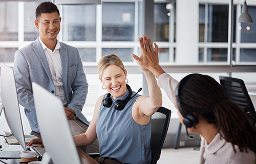 An IT team celebrates a success