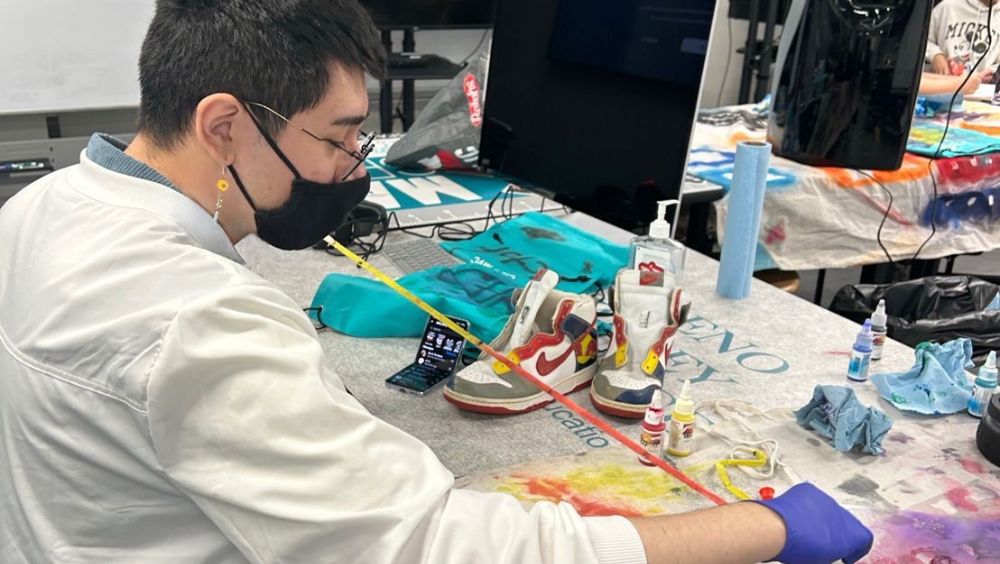 Martinez creating artwork while dressed in protective equipment