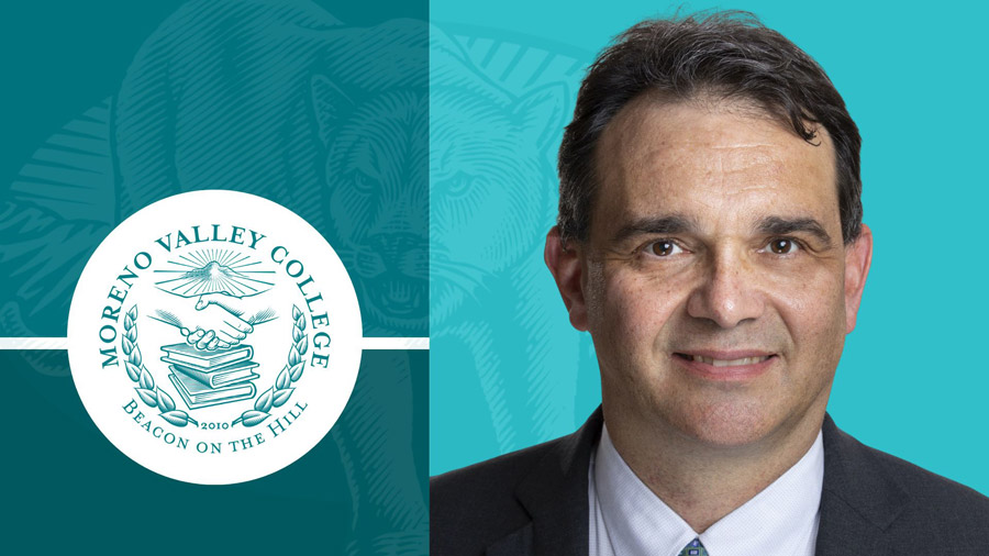 Portrait of Rudy Besikof next to college seal