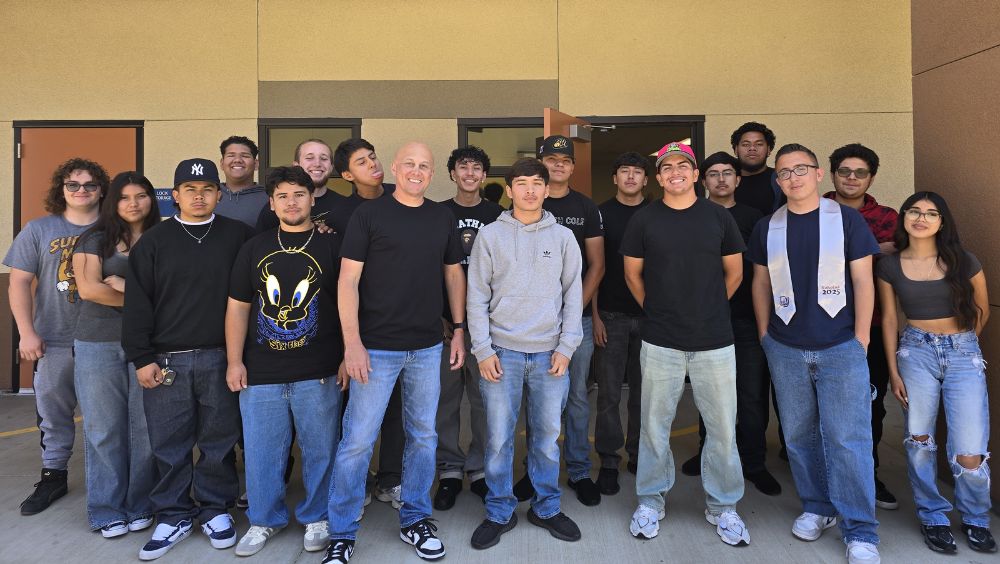 Fire technology dual enrollment students and professor Clemons gather in front of their classroom
