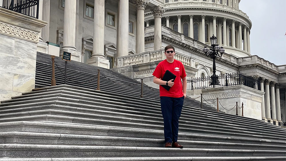 Peak stands on the Capitol Building steps in Washington, DC