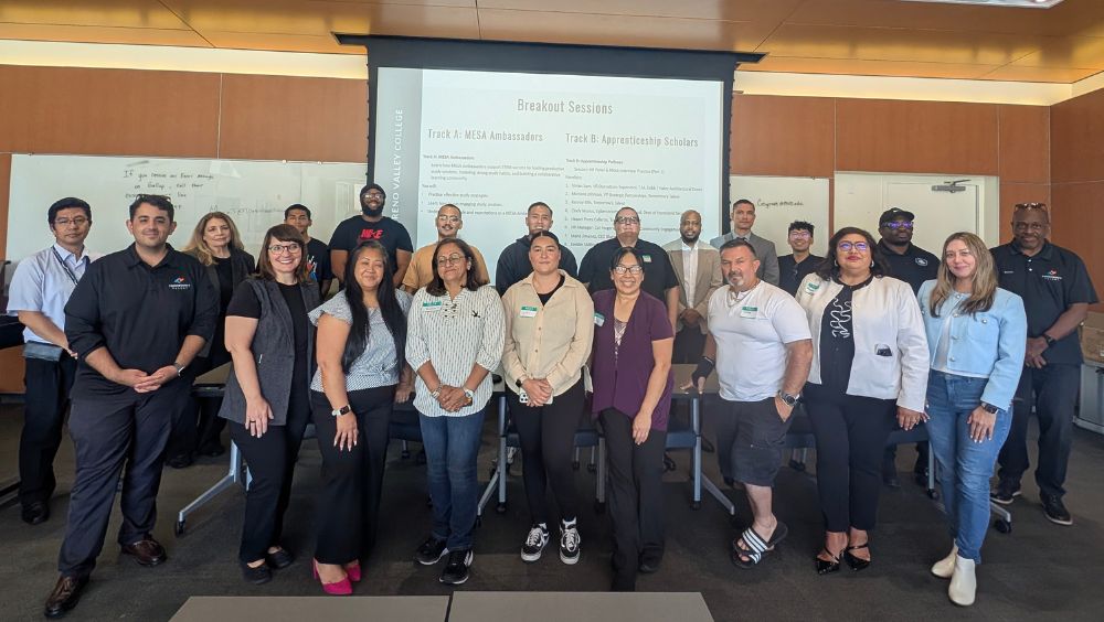 Group photo of summit attendees in an MVC classroom