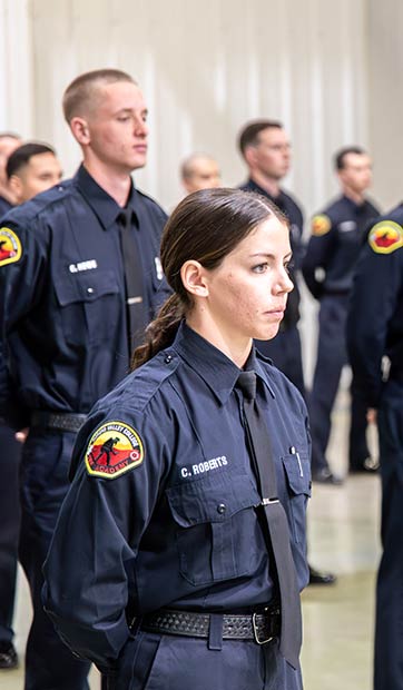 A fire academy student lined up with peers