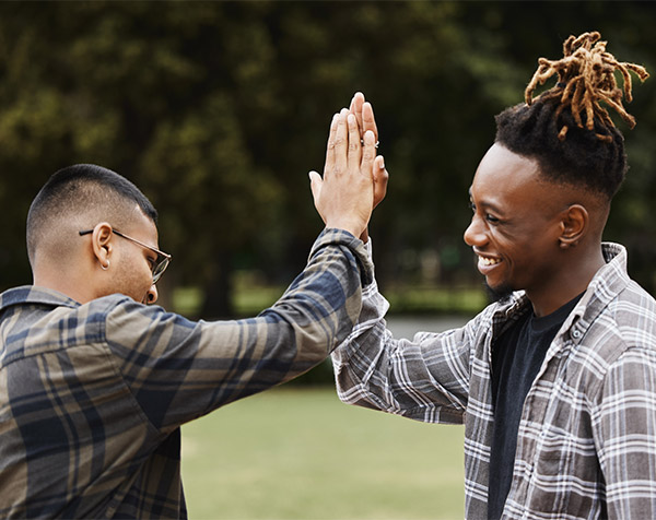Two male students high fiving