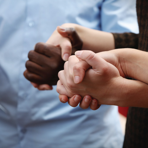 A group of people holding hands in unity